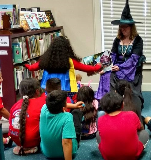 Miss Julie reading an interactive Halloween story 494x523